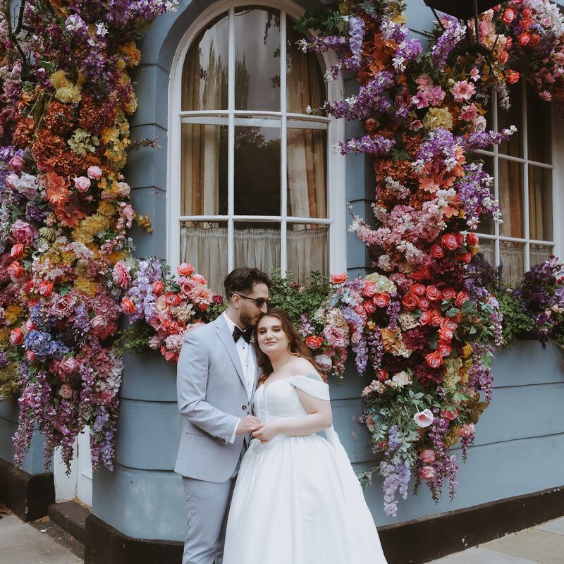 Couple at flower wall